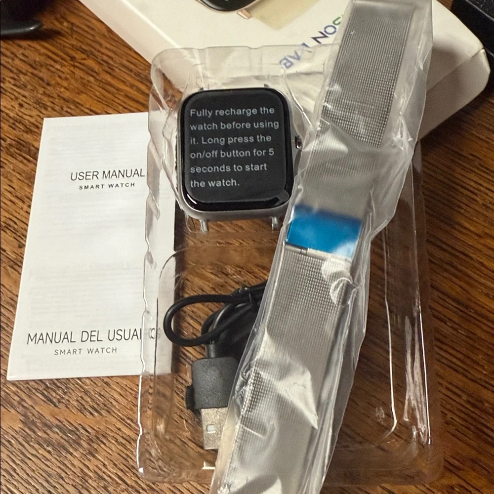 Silver Simpson lab smart watch. Comes with charger and band